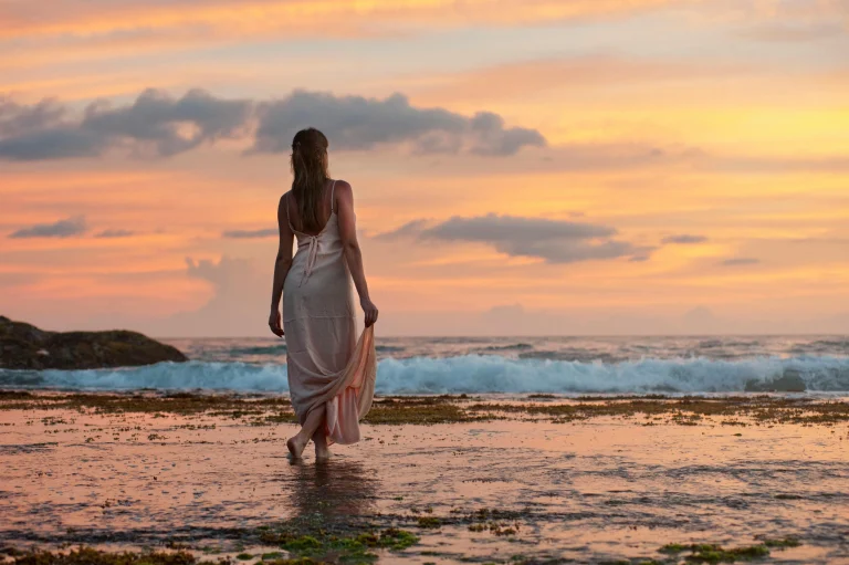 Essencylon Sri Lanka Travel Guide | Private Tours & Expert Tips 3 Woman walking along a Sri Lanka beach at sunset — Sri Lanka local tour operator Essencylon