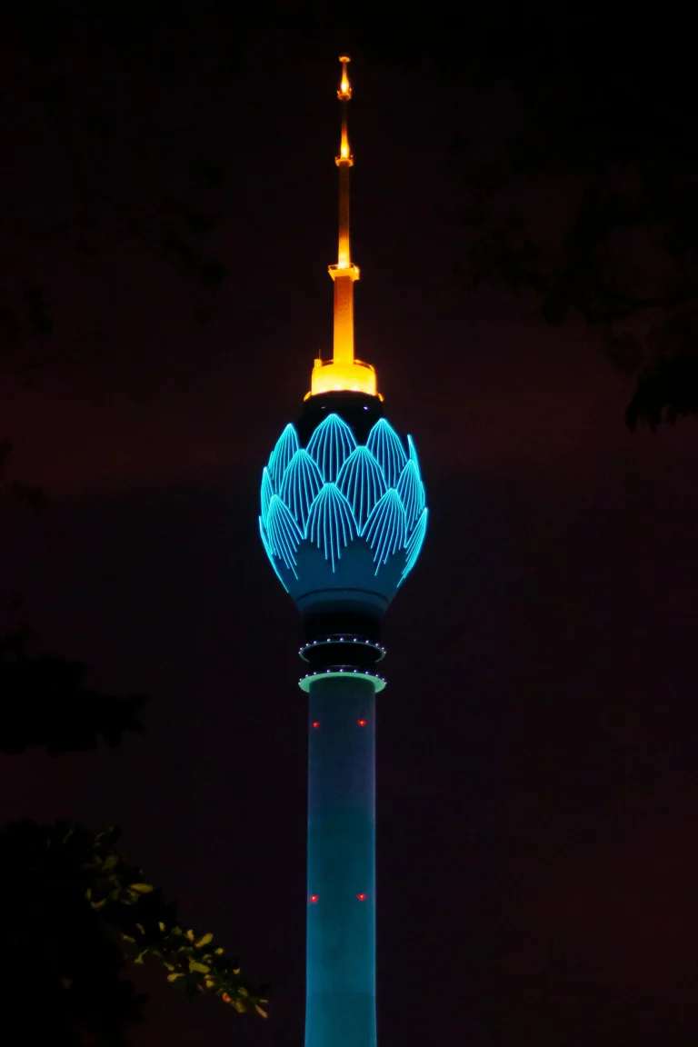 Sri Lanka Airport Transfer: What to Expect When You Land at Colombo (CMB) 2 Colombo Lotus Tower illuminated at night with vibrant blue and golden lights against a dark sky